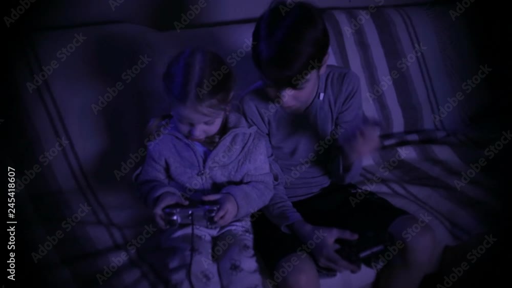 brother and sister play a computer game with joysticks brother and sister play a computer game with joysticks