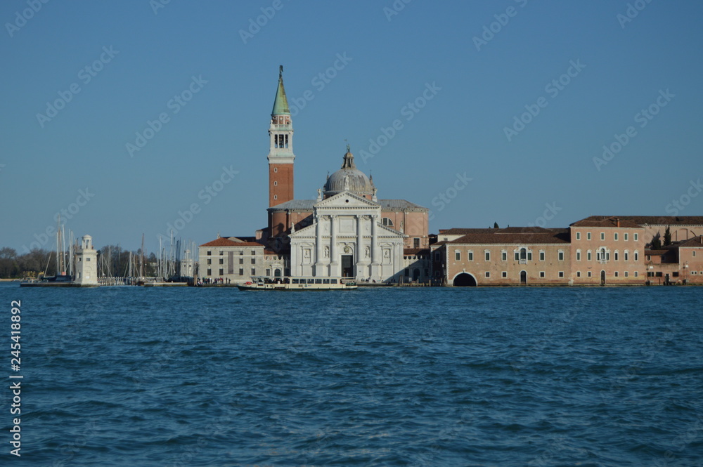 Facade Of The Church Of San Giorgio Maggiore And Its Spectacular Bell Tower With A Vaporeto Crossing Through In Venice. Travel, holidays, architecture. March 28, 2015. Venice, Veneto, Italy.