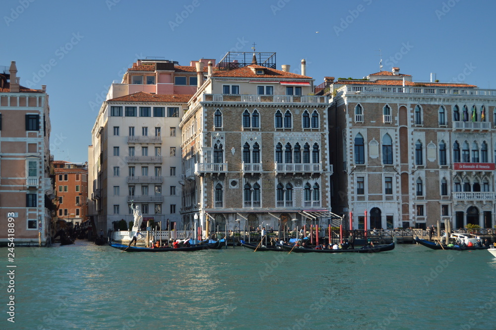 Grand Canal With Gondolas Walking To Tourists Background A Picturesque Venetian Palaces In Venice. Travel, holidays, architecture. March 28, 2015. Venice, Veneto region, Italy.