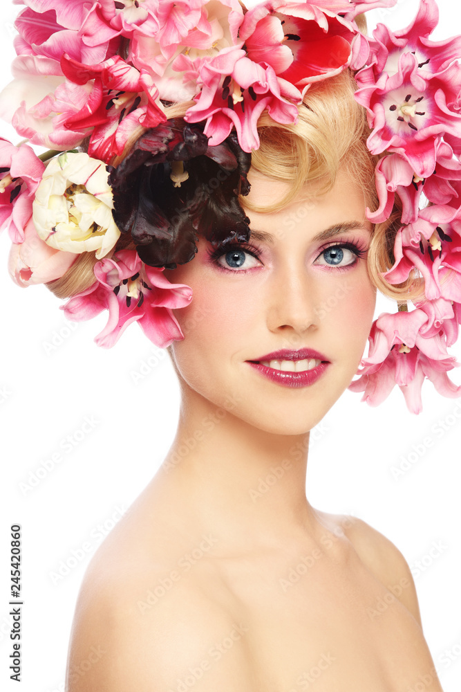 Young beautiful smiling girl with fancy make-up and colorful flowers in her hair Young beautiful smiling girl with fancy make-up and colorful flowers in her hair