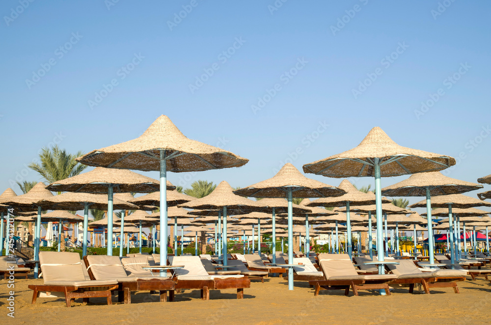Many beach umbrella from wicker and lounge Hurgada, Egypt