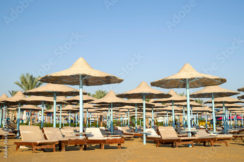 Many beach umbrella from wicker and lounge Hurgada, Egypt © isabela66