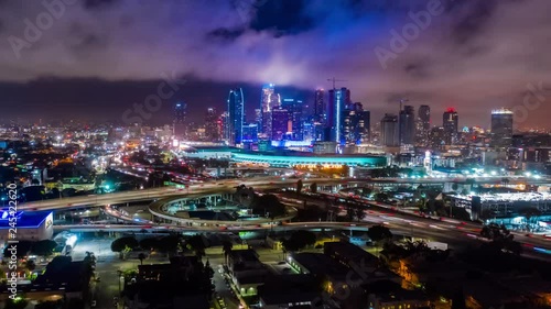 4K aerial urban hyperlapse ( timelapse in motion ) clip of downtown and freeways interchange at night and convention center