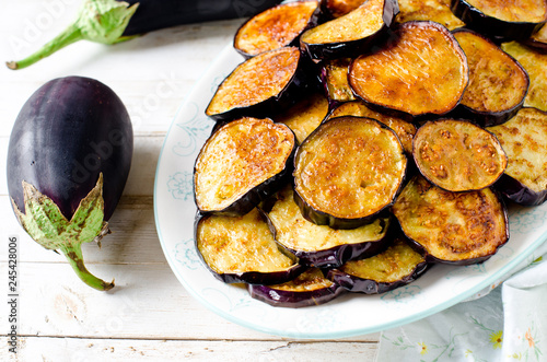 Fried eggplant on a plate on a wooden table