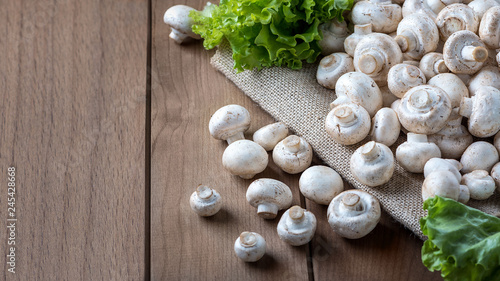 Fresh champignons on a wooden table.