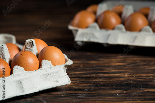 chicken eggs on old wooden board with blank space for text