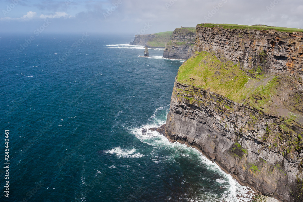 Coast of Ireland with beautiful Cliffs of Moher located in Burren region in County Clare Coast of Ireland with beautiful Cliffs of Moher located in Burren region in County Clare