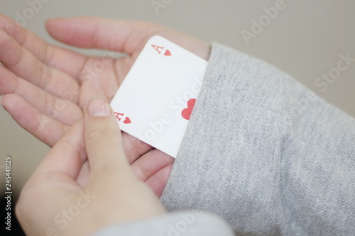 Concept image of a person hiding an ace up their sleeve.