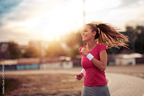 Young woman running in the city street