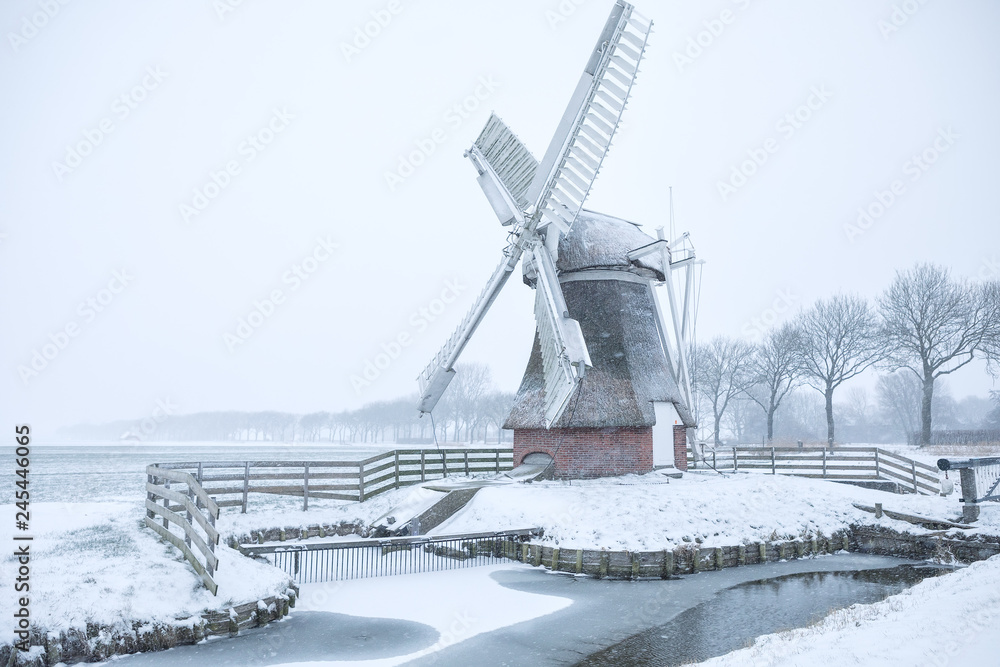Dutch windmill during wintry snowfall
