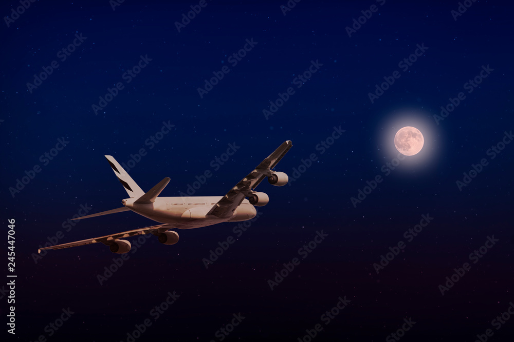 A plane flying towards a beautiful moonlight