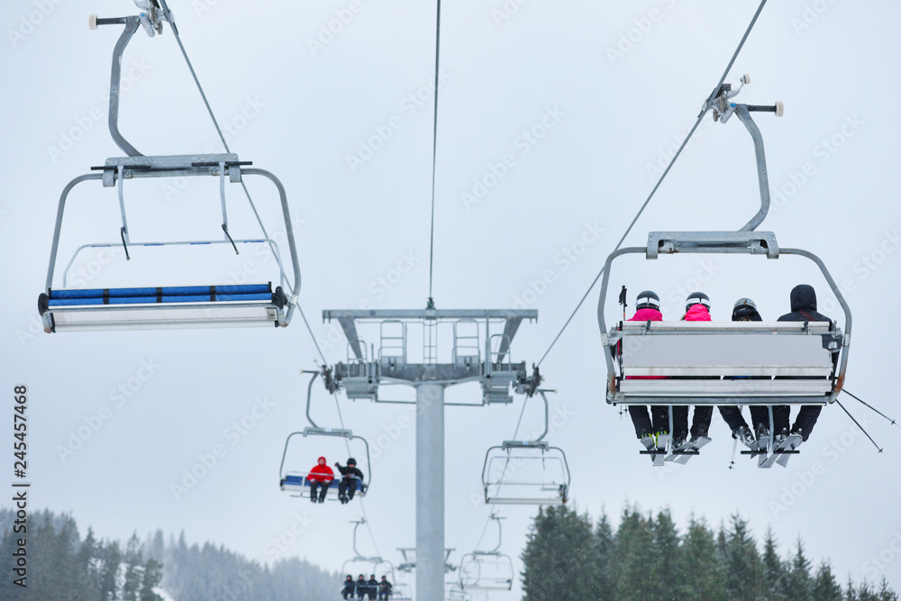 Chairlift with people at ski resort. Winter vacation Chairlift with people at ski resort. Winter vacation