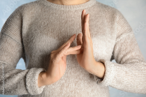 Woman showing word Jesus, closeup. Sign language photo