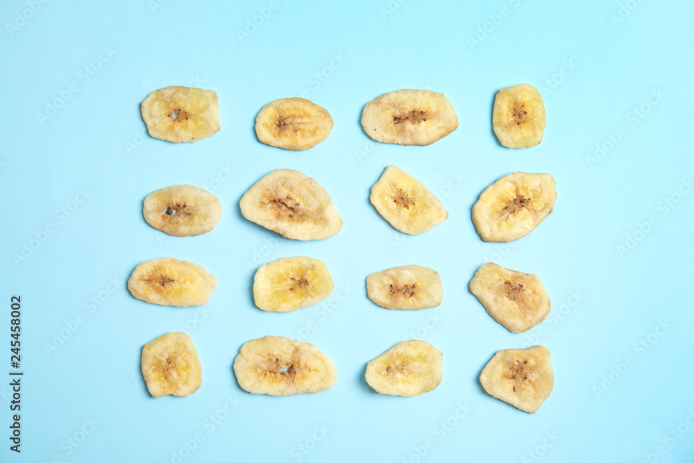 Flat lay composition with banana slices on color background. Dried fruit as healthy snack Flat lay composition with banana slices on color background. Dried fruit as healthy snack
