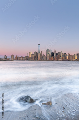 Photography View on Financial District at sunrise from hudson river beach with long exposure