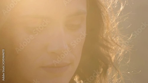 close up portrait of beautiful woman enjoying peaceful sunset exploring spirituality looking up praying contemplating journey with wind blowing hair photo