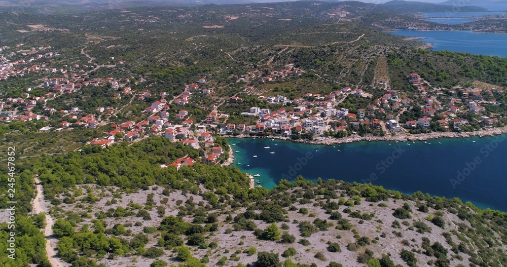 Mediterranean town, C4k aerial, tracking, pan, drone shot, of the Razanj village, on  the croatian coast and the turquoise, adriatic sea, on a sunny, summer day, in Croatia