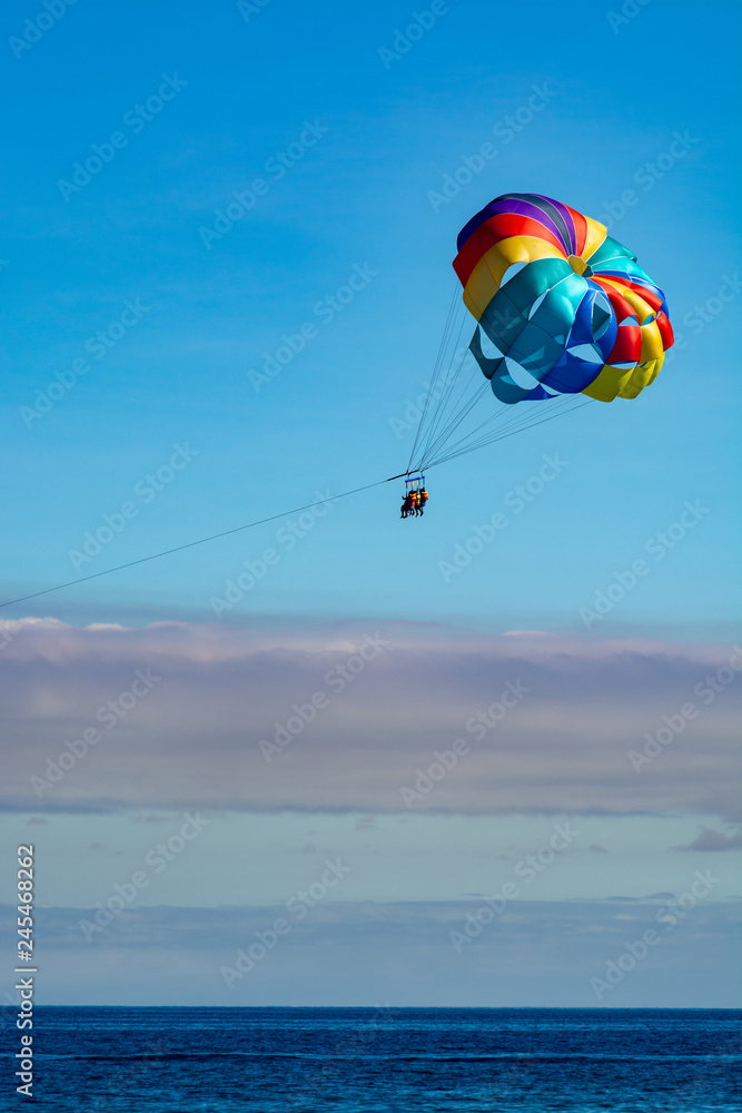 Sea and beach sport for tourists, parasailing in blue sky Sea and beach sport for tourists, parasailing in blue sky