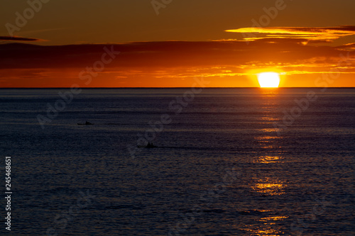 Scenic colorful sunrise over dark blue ocean water