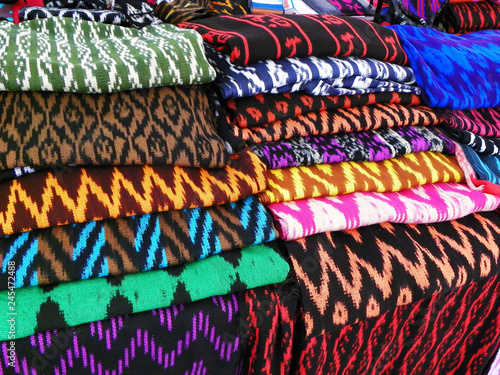 Ecuadorian scarves or Macanas. Traditional colorful craft and design for Gualaceo canton, Azuay province on the display at street market. Scarves made by technique called IKAT from cotton or wool. 