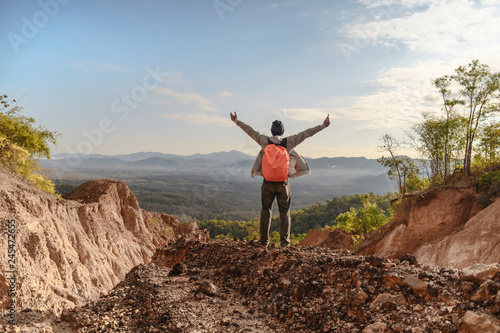 Tourist on the peak of high rocks. Sport and active life concept © aedkafl