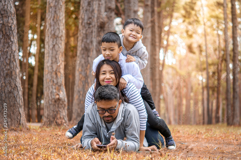 Fototapeta premium Young family with children having fun in nature
