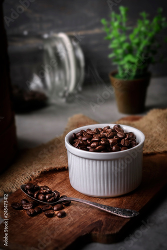 Coffee cup and beans on old kitchen table.