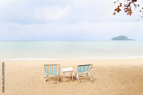 Beach chairs on the sand beach for summer concept