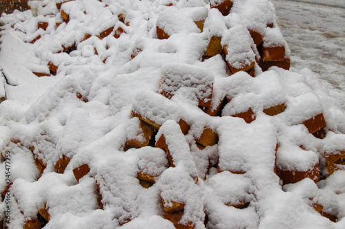 Red bricks covered with snow
