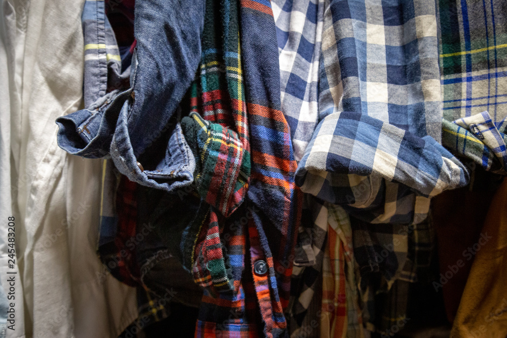Assorted Men's Shirts Hanging in a Closet