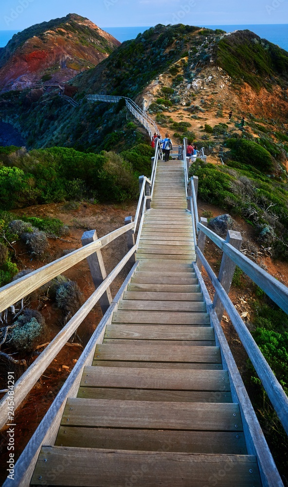 A staircase descends down a rocky track