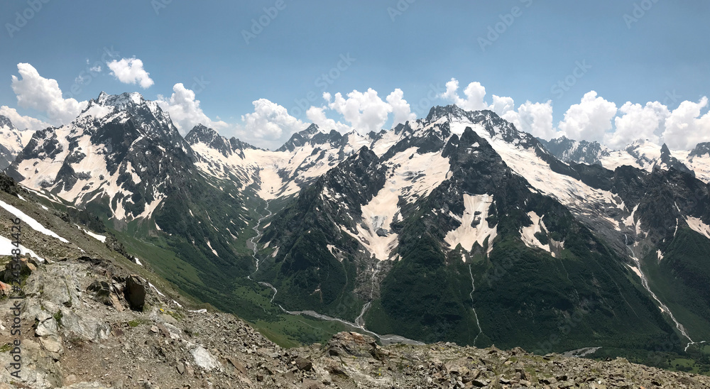 panorama of snow-capped mountain peaks on a Sunny summer day panorama of snow-capped mountain peaks on a Sunny summer day