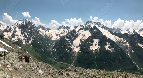 panorama of snow-capped mountain peaks on a Sunny summer day