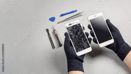 Technician or engineer prepairing to repair and replace new screen broken and cracked screen smartphone prepairing on desk with copy space photo