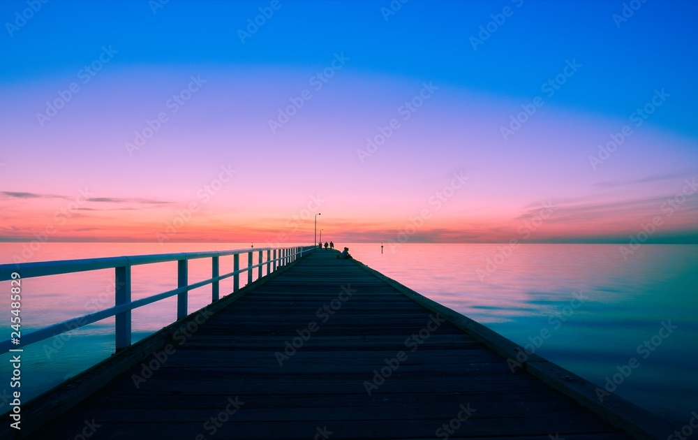 Blue light after sunset over a long pier