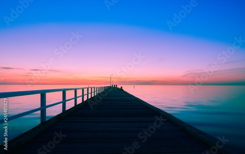 Fototapeta Naklejka Na Ścianę i Meble -  Blue light after sunset over a long pier