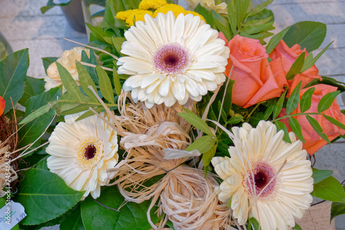 pale white gerber and one orange rose flowers bouquet closeup photo