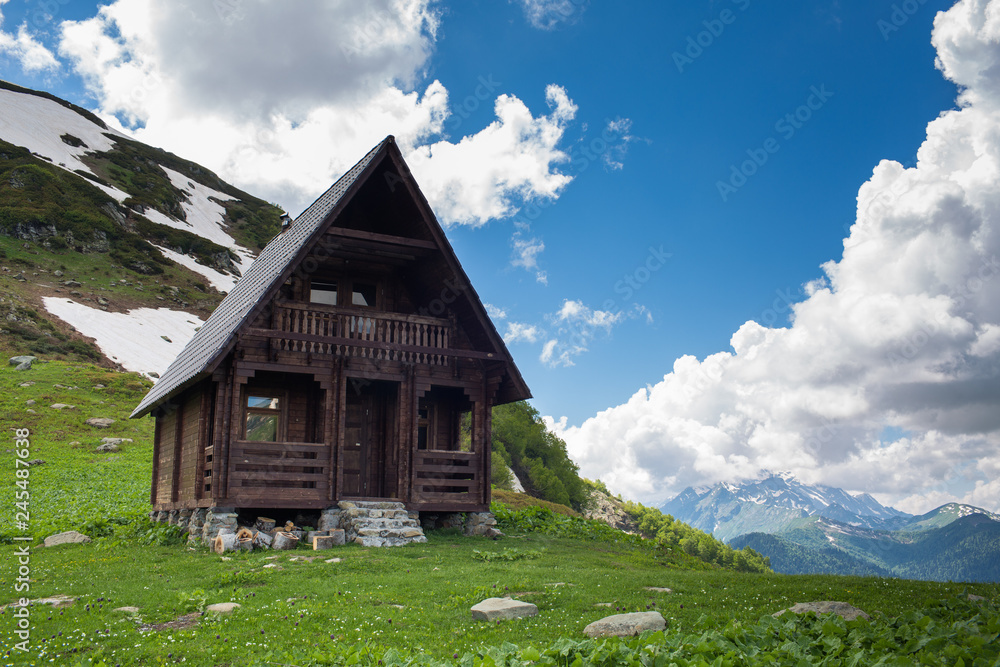 wooden two-storey cottage in the mountains