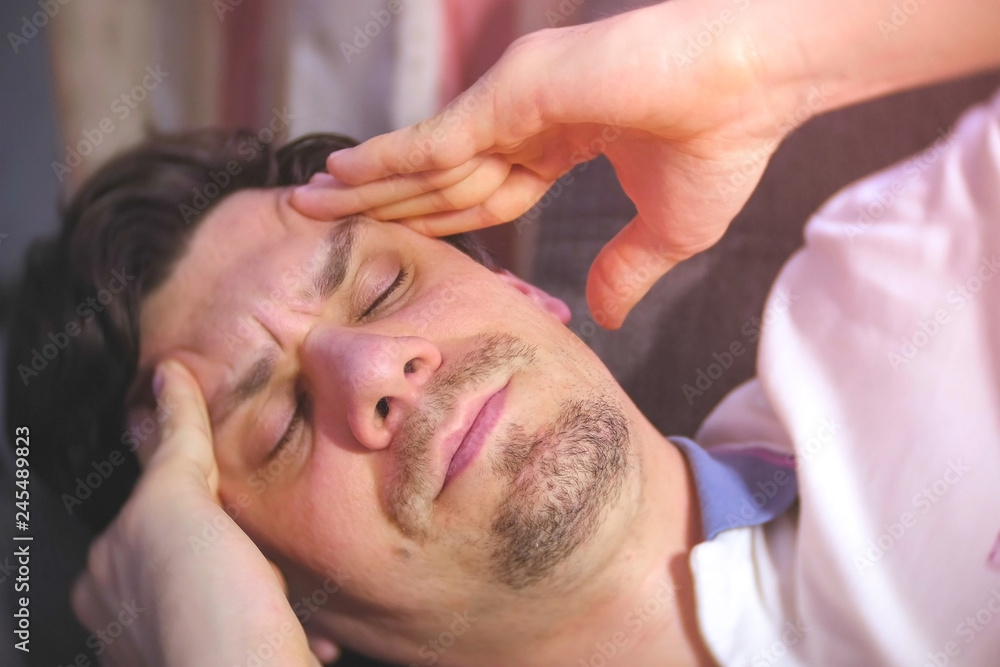 Young man with a headache lying on the couch. Young man with a headache lying on the couch.