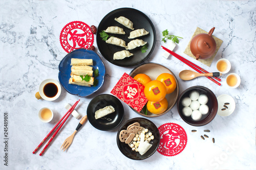 Flat lay Chinese new year food and drink on marble table top.