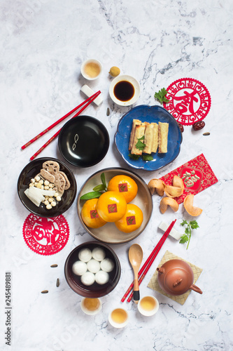 Flat lay Chinese new year food and drink on marble table top.