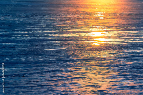 The ice on the river glitters beautifully in the sunlight photo