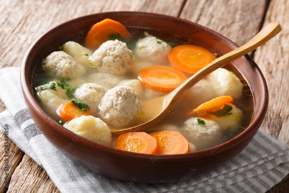 Delicious Danish soup with meat balls, dumplings and vegetables close-up in a bowl. horizontal Delicious Danish soup with meat balls, dumplings and vegetables close-up in a bowl. horizontal