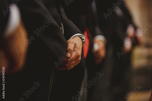 Unrecognizable man dressed in suit with interlaced hands