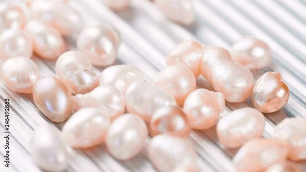 Rose gold pearls on metal surface. Close up of pink jewelry 4k footage. Rose gold pearls on metal surface. Close up of pink jewelry 4k footage.