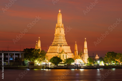 View of the Wat Arun temple on the night illumination at sunset. Bangkok, Thailand
