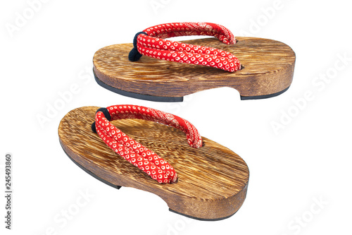 Fotografie Close up old used wooden Japanese sandal isolated on white background