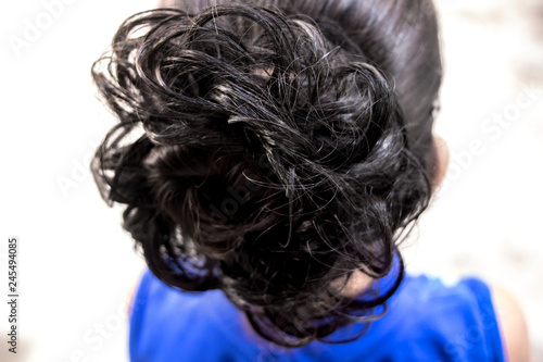 hairstyle bun on the brunette on isolated light background