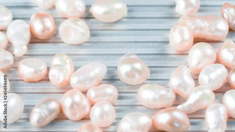 Rose gold pearls on metal surface. Close up of pink jewelry 4k footage. Rose gold pearls on metal surface. Close up of pink jewelry 4k footage.