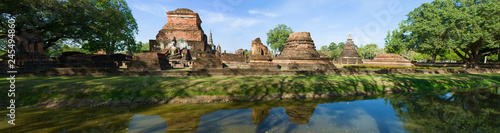 Panorama of the ruins of the ancient Buddhist temple of Wat Mahathat in a sunny day. Sukhothai, Thailand